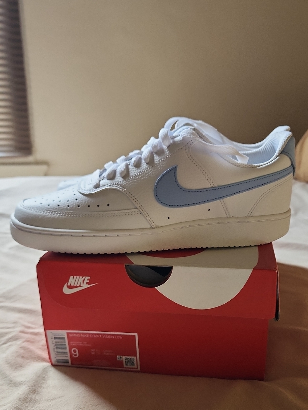 Nike Women's Court Vison Low-Top Sneakers in White with Light Blue Swoosh